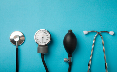 Black blood pressure monitor on a blue background. Medical equipment blood pressure monitor....