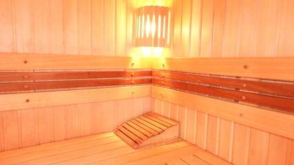 Fototapeta na wymiar Standard Finnish wooden sauna cabin interior.Empty interior of huge sauna