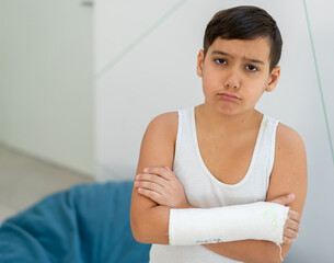 Boy keeps broken arm in gypsum, plaster arm, accident at home , injury, trauma concept. High quality photo