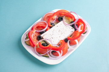 top view of greek salad on blue background