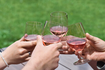 Group of people toasting with glasses of wine outdoors
