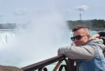 Middle aged man looking at Niagara Falls Canada