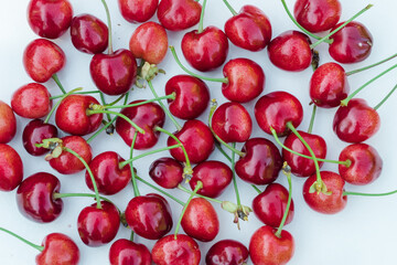 Lots of sweet red cherries isolated on a white background closeup. Red cherries texture or background