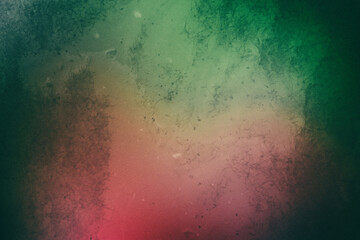 Retro photo of red-green blurred background with the effect of fading and old spots with noise on the film.