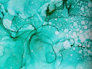 Abstract green and gold fragment of colorful background, wallpaper. Mixing acrylic paints. Modern art. Marble texture. Alcohol ink colors translucent.Alcohol Abstract contemporary art fluid.