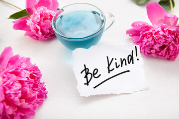 Be kind - card with calligraphy lettering and pink peony flowers and blue tea, motivation phrase about goodness	