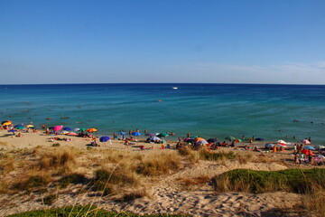 The beach of san pietro in bevagna with a lot of people