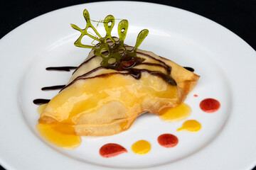 Crepes served on a white plate, sweet dessert for breakfast, professional food presentation, exclusive event meal.
