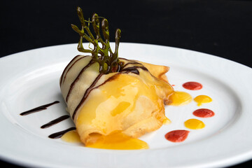 Crepes served on a white plate, sweet dessert for breakfast, professional food presentation, exclusive event meal.