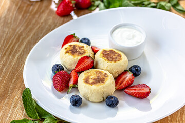 Homemade cheesecake with fresh strawberries and blueberries dessert - healthy organic summer dessert pie cheesecake. Vanilla Cheese Cake