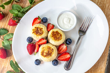 Homemade cheesecake with fresh strawberries and blueberries dessert - healthy organic summer dessert pie cheesecake. Vanilla Cheese Cake