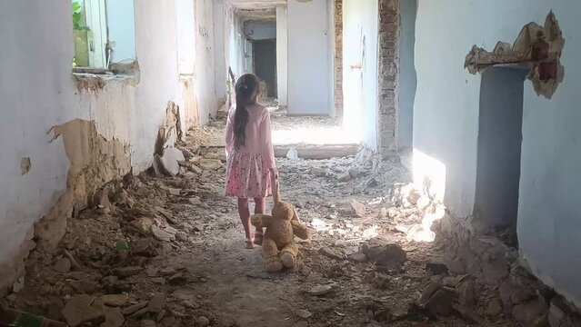 Children against war. A child with a toy in a bomb shelter. War in Ukraine. Peace concept. Consequences of the war in Ukraine. A child in a destroyed house. Ukrainian children in ruins.