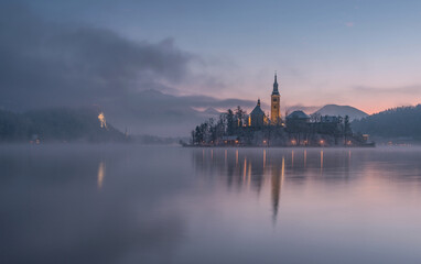 Fototapeta na wymiar Lake Bled with the church and the castle on a calm winter morning