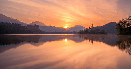 Fototapeta premium Lake Bled on a fierce and vivid sunrise day