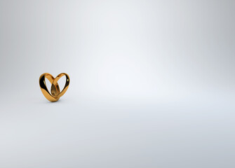 Gold wedding rings positioned to form a heart on a soft white background for save the date, invitations and place cards
