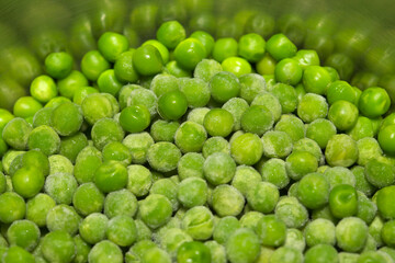 Partially defrosted frozen peas, macro food background
