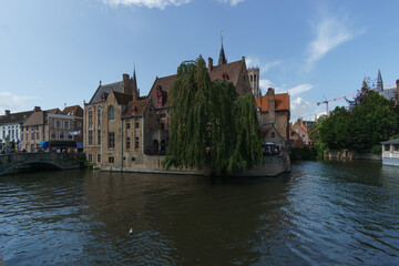 Fototapeta premium Cityscape of houses with canal of water at Rozenhoedkaai, Bruges, Belgium