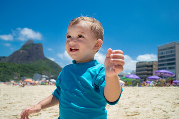 Beautiful little boy on the sand of Copacabana beach, Rio de Janeiro, Brazil