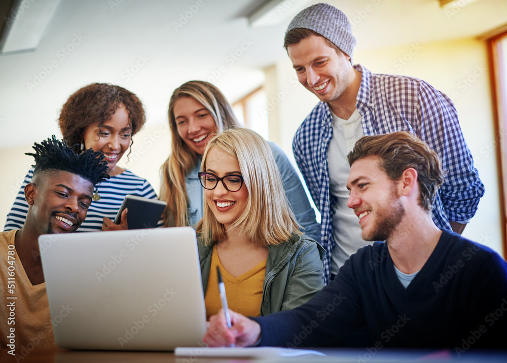 Poster Students who work together in collaborative teams learn material better. Shot of a group of university students working together on a laptop in the library at campus.