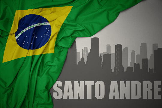 Abstract Silhouette Of The City With Text Santo Andre Near Waving National Flag Of Brazil On A Gray Background.