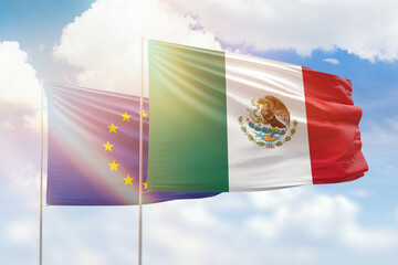 Sunny blue sky and flags of mexico and european union