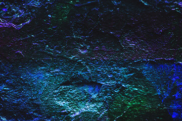 Abstract texture. Rock texture. Dark stone wall. Stone background. Rock surface with holography, nacre. Stone texture for designers. Wall abstraction. Paint spots. Rock surface with cracks.
