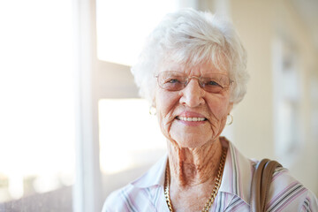 The weathers perfect for a day out. Portrait of a happy elderly woman getting ready to go out.