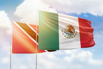 Sunny blue sky and flags of mexico and trinidad and tobago