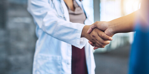 I look forward to working with you in the operation room. Closeup shot of two medical practitioners shaking hands.