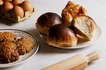 Set of pastries, breads, brioches, handmade cookies, eggs on a white background and kitchen and pastry utensils