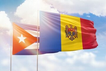 Sunny blue sky and flags of moldova and cuba