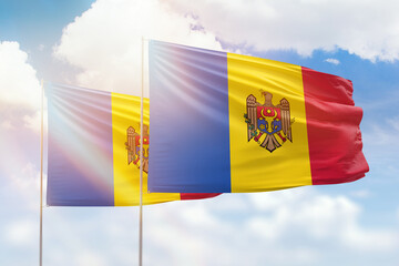 Sunny blue sky and flags of moldova and moldova