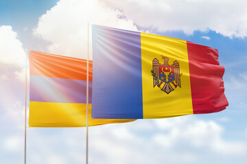 Sunny blue sky and flags of moldova and armenia
