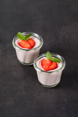 Strawberry cream pudding, Panna Cotta in a glass. Dark grey background