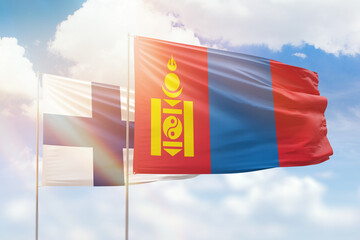 Sunny blue sky and flags of mongolia and finland