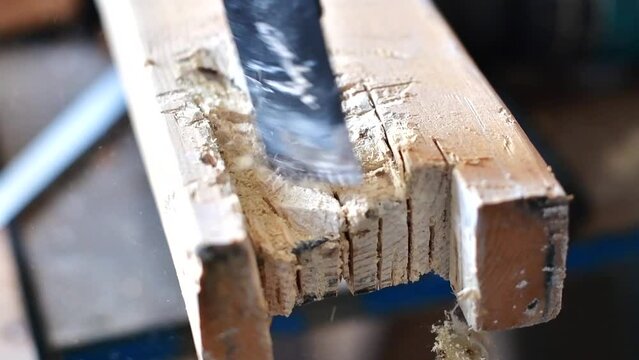 Cutting wood on a chap-saw, close up on the blade
