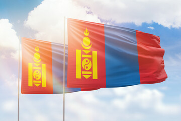 Sunny blue sky and flags of mongolia and mongolia