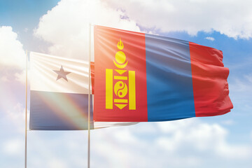 Sunny blue sky and flags of mongolia and panama