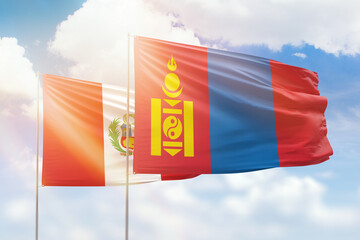 Sunny blue sky and flags of mongolia and peru