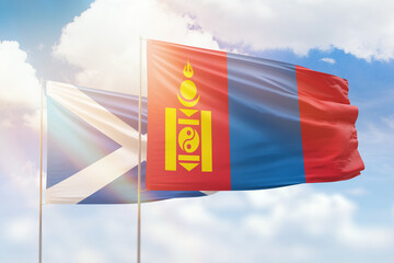 Sunny blue sky and flags of mongolia and scotland