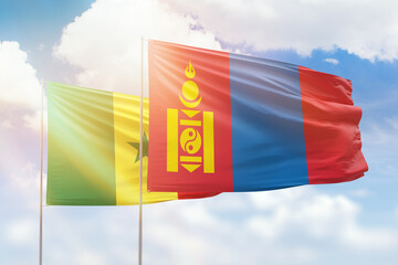 Sunny blue sky and flags of mongolia and senegal