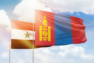 Sunny blue sky and flags of mongolia and syria