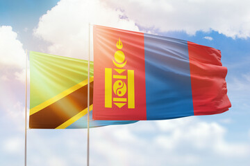 Sunny blue sky and flags of mongolia and tanzania