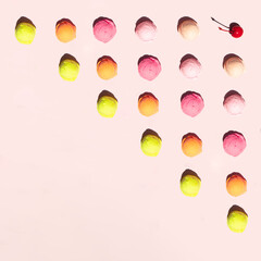 Pastel light ice cream balls and cherry pattern on light pink background. Creative tasty food concept. Minimalistic sweets composition with copy space. Sunny summer idea.