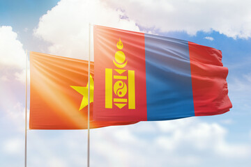 Sunny blue sky and flags of mongolia and vietnam
