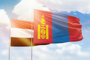 Sunny blue sky and flags of mongolia and yemen