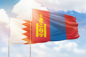 Sunny blue sky and flags of mongolia and bahrain