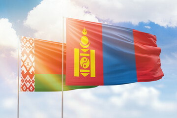Sunny blue sky and flags of mongolia and belarus