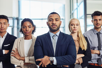 Strive for success and you team will follow suit. Shot of a group of confident and diverse young businesspeople working together in a modern office.