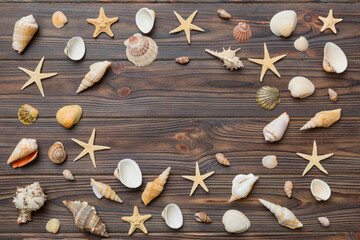 Summer time concept Flat lay composition with beautiful starfish and sea shells on colored table, top view with copy space for text